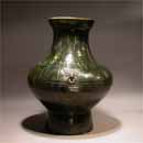 A Green Glazed Pottery Jar with Mask Ring Handles