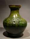 A Green Glazed Pottery Jar with Mask Ring Handles