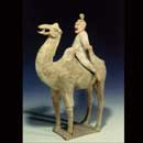 A Painted Red Pottery Figure of a Camel and Rider