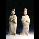 A Rare and Large Pair of Painted Red Pottery Figures of a Fat Lady and a Man
